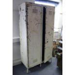 A mid-20th century white painted art-metal industrial locker fitted two shelves enclosed by pair
