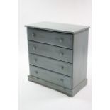 A blue painted pine chest of four long drawers, with turned knob handles, & on plinth base; 33”