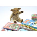 A golden plush teddy bear, 17½” tall; together with various children’s books & annuals.