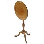 A 19th century tripod table with circular tilt-top, & on vase-turned centre column & three
