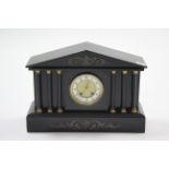 A 19th century mantel clock with white enamel & brass two-part dial, with striking movement & in