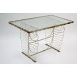 A white painted wrought-iron garden table on shaped end supports joined by plain stretchers, & in