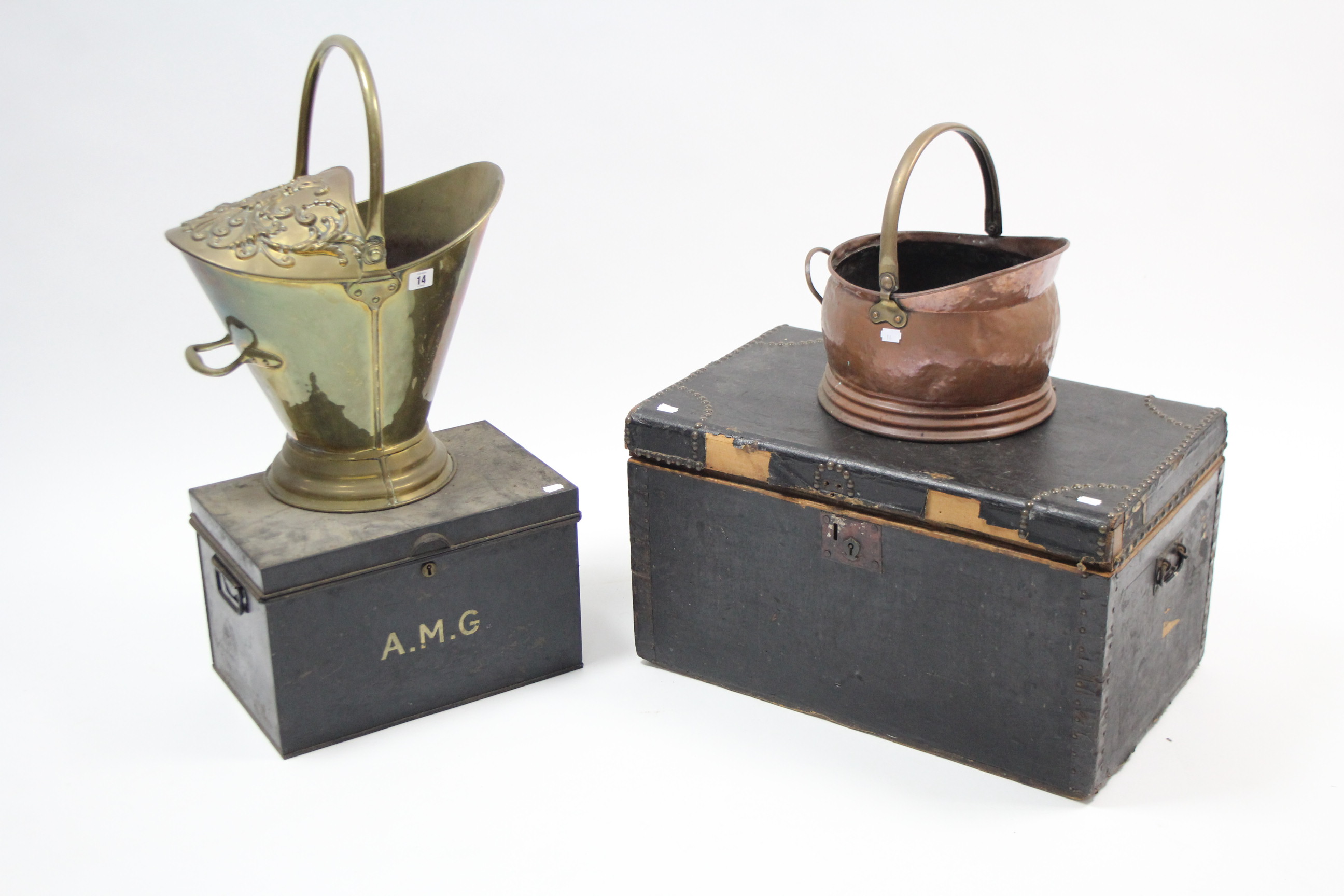 A brass embossed helmet-shaped coal scuttle; a copper coal scuttle; & two storage boxes.