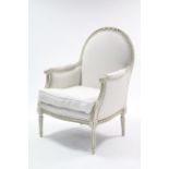 A continental-style white painted & carved wooden frame armchair with domed padded back & loose