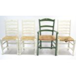 A set of three white painted oak ladder-back kitchen chairs with woven-rush seats, & on turned