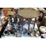 An Eastern brass engraved circular tray-top occasional table on folding wooden stand, 23”