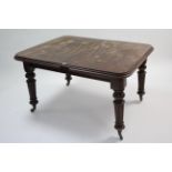 A Victorian mahogany extending dining table with additional leaf, wind-out mechanism, & on