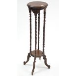 A mahogany circular jardinière stand on spiral-twist supports & cabriole legs, 39½” high.