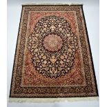 A Persian pattern rug of deep blue, crimson & ivory ground, with centre medallion surrounded by