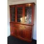 A mahogany tall standing cabinet, the upper part fitted nine shelves enclosed by three glazed doors,