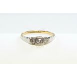 An 18ct. gold & platinum ring set three small diamonds.