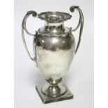 A George V ovoid two-handled vase with gadrooned neck-rim & shoulder, on square pedestal foot, 6¾”