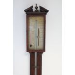 A late George III stick barometer, in mahogany case with inlaid chequered borders, the engraved