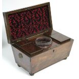 A regency figured mahogany rectangular tea caddy with tapered sides, brass lion-mask & ring side