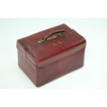 A crimson morocco travelling toilet case. (Lacking interior fitments).