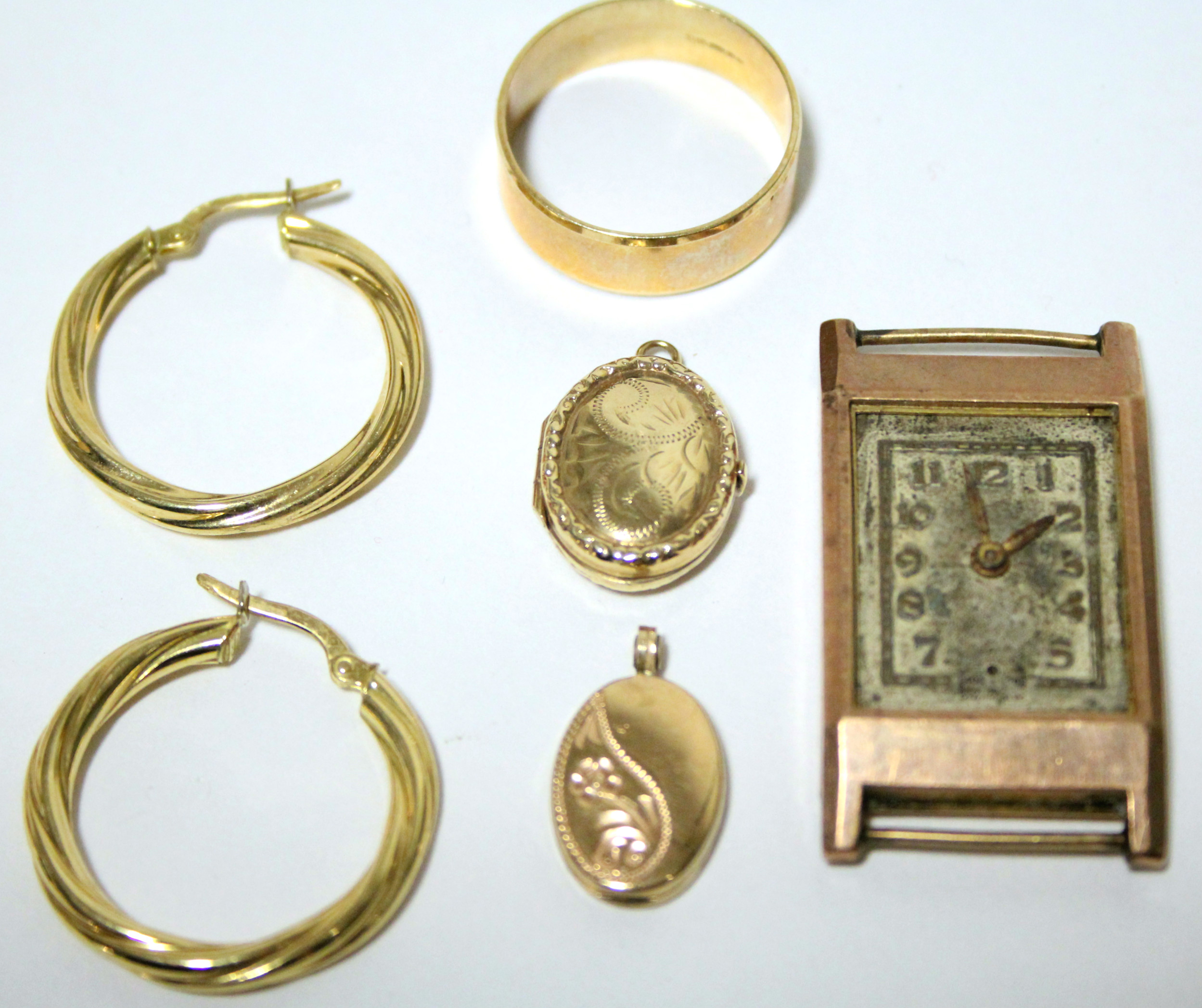 A 9ct. gold plain wedding band; a pair of 9ct. hoop earrings; two small 9ct. oval pendant lockets; &