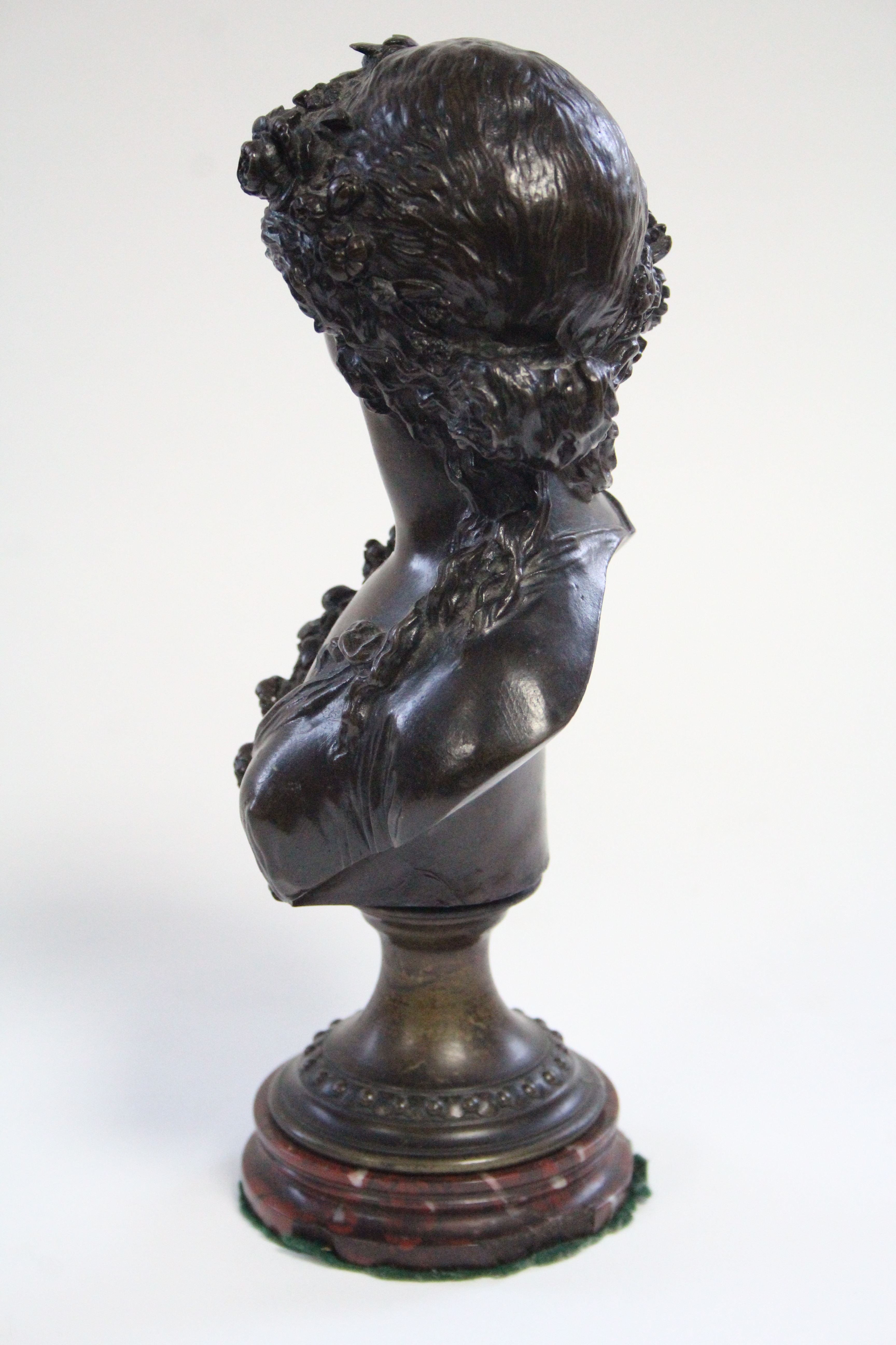 A 19th century bronze bust of a young woman with floral garland in her hair, on round socle & - Image 3 of 4