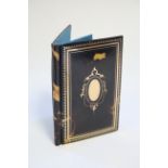 A late Victorian tortoiseshell & gold piquet-work note book with blue moiré silk interior; 4¼” x