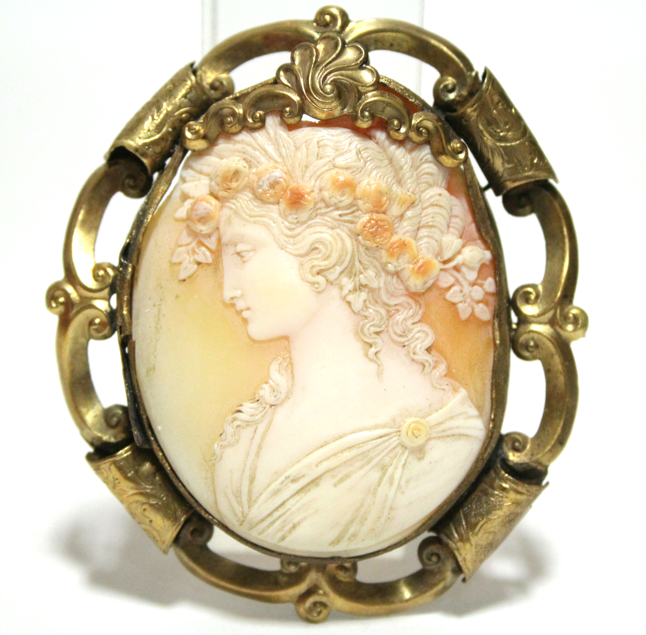 A 19th century carved shell oval cameo brooch depicting the Goddess Flora, 2” x 1½”; in pierced &