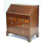 A George III inlaid-mahogany & satinwood crossbanded bureau, the sloping fall-front enclosing a