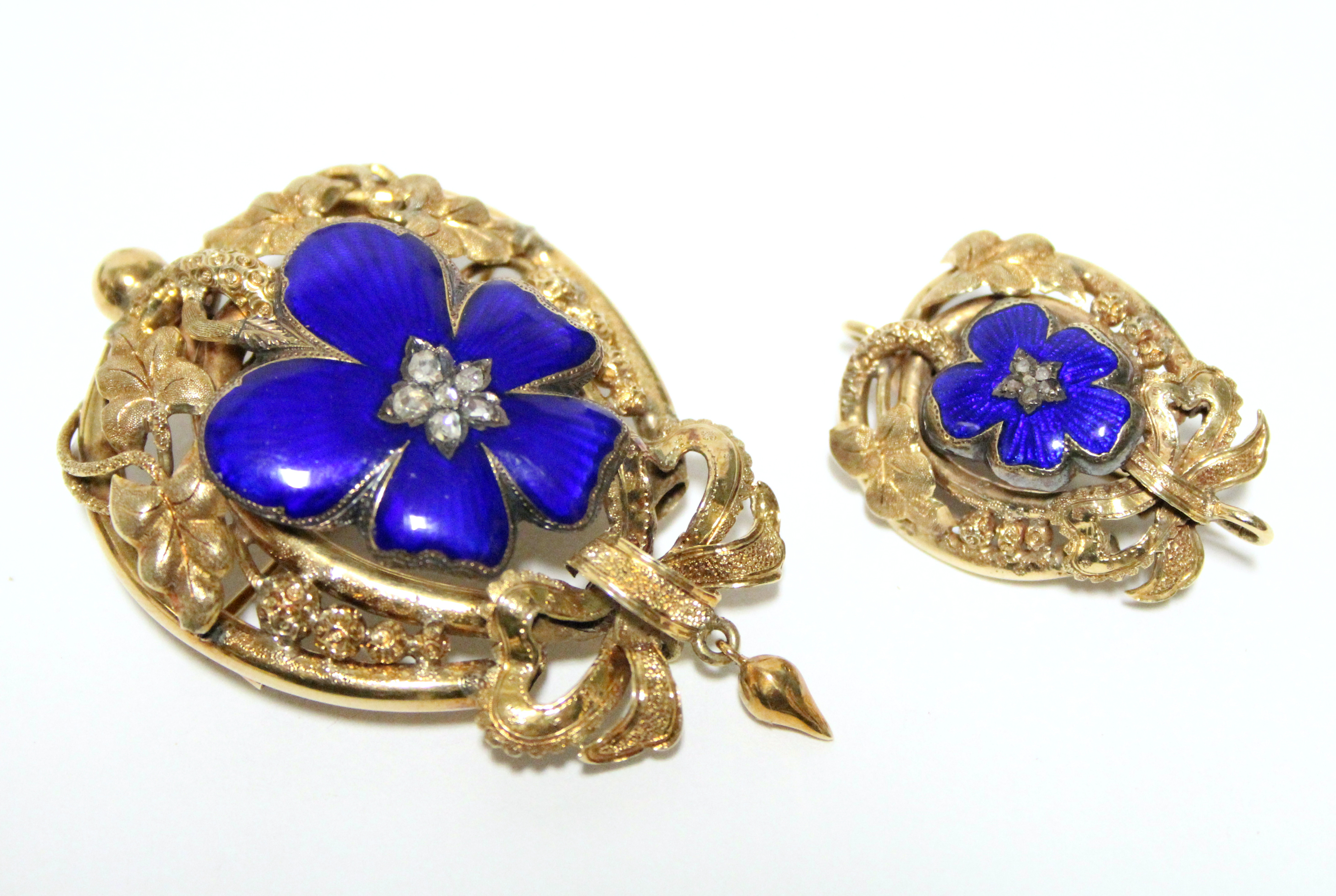 A VICTORIAN GOLD, BLUE ENAMEL, & DIAMOND BROOCH of oval shape with pierced leaf-scroll border &