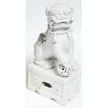 An 18th century Chinese blanc-de-chine large seated Buddhistic lion, his right fore-paw resting on a