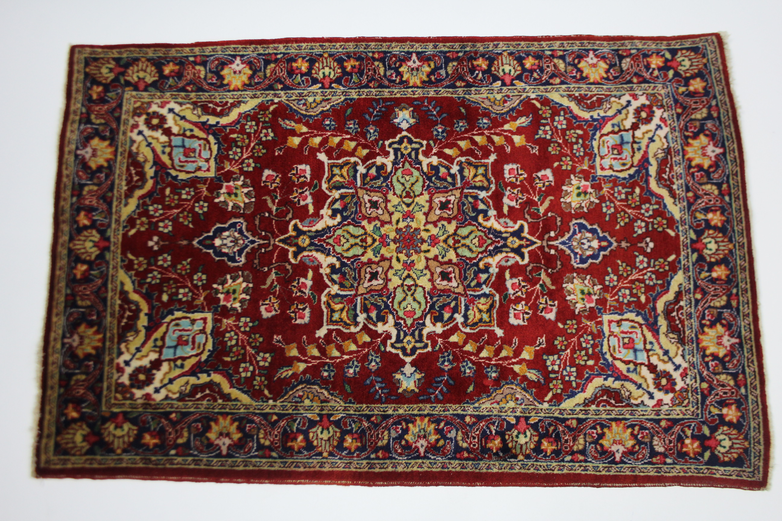 A Hamadan rug of crimson & blue ground, with central medallion surrounded by floral spandrels within