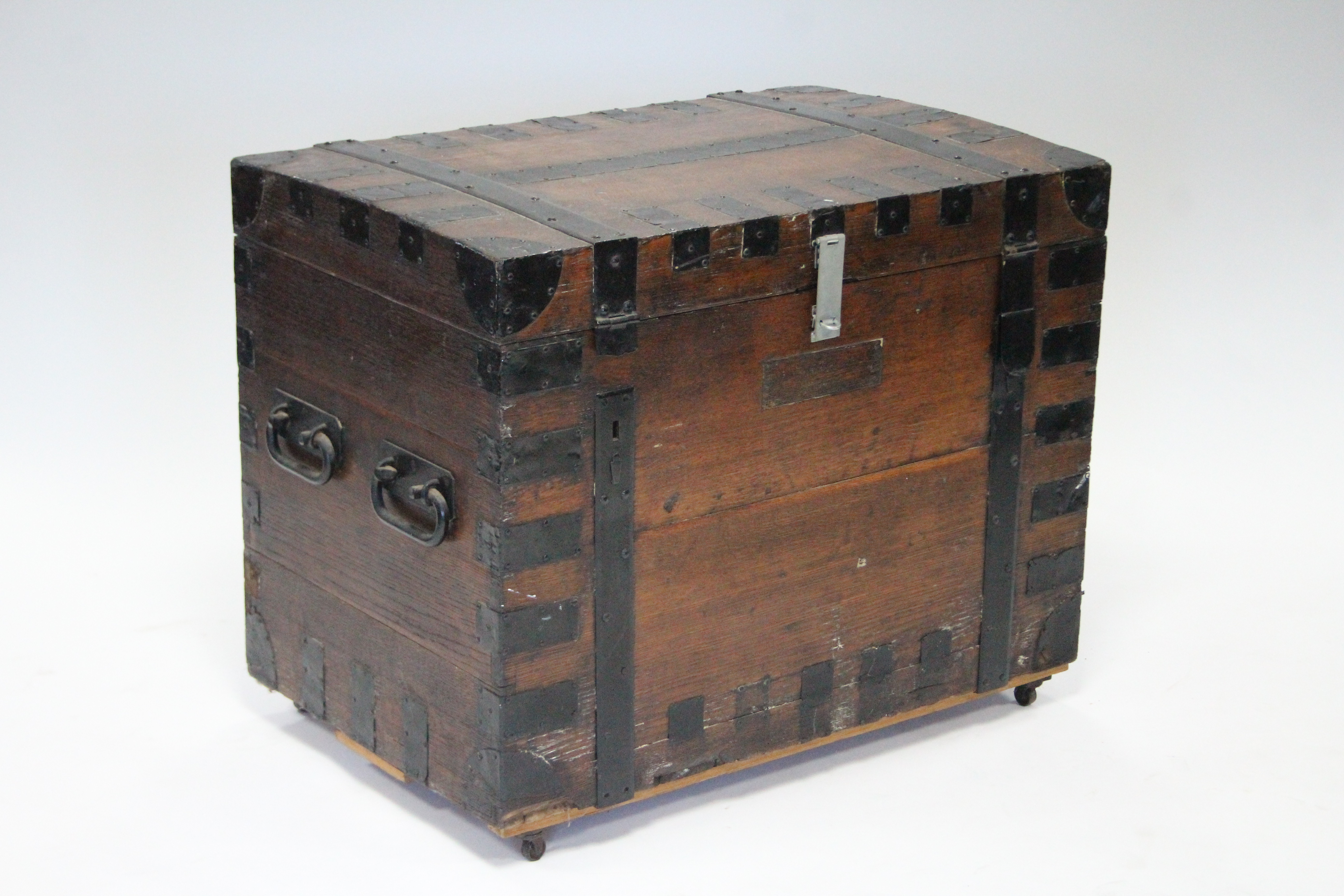 A 19th century OAK & IRON BOUND PLATE CHEST with hinged lift-lid, double swing carrying handles, &