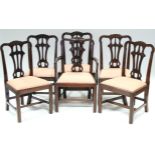 A set of six 18th century Irish mahogany dining chairs, including one elbow chair, with carved &