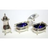 A modern three-piece condiment set with gadrooned rims, each on four pad feet, the mustard pot &