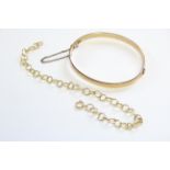 A 9ct. gold bracelet of circular wire links; 7¼” long (6.6 gm); & a 9ct. & metal-core engraved stiff