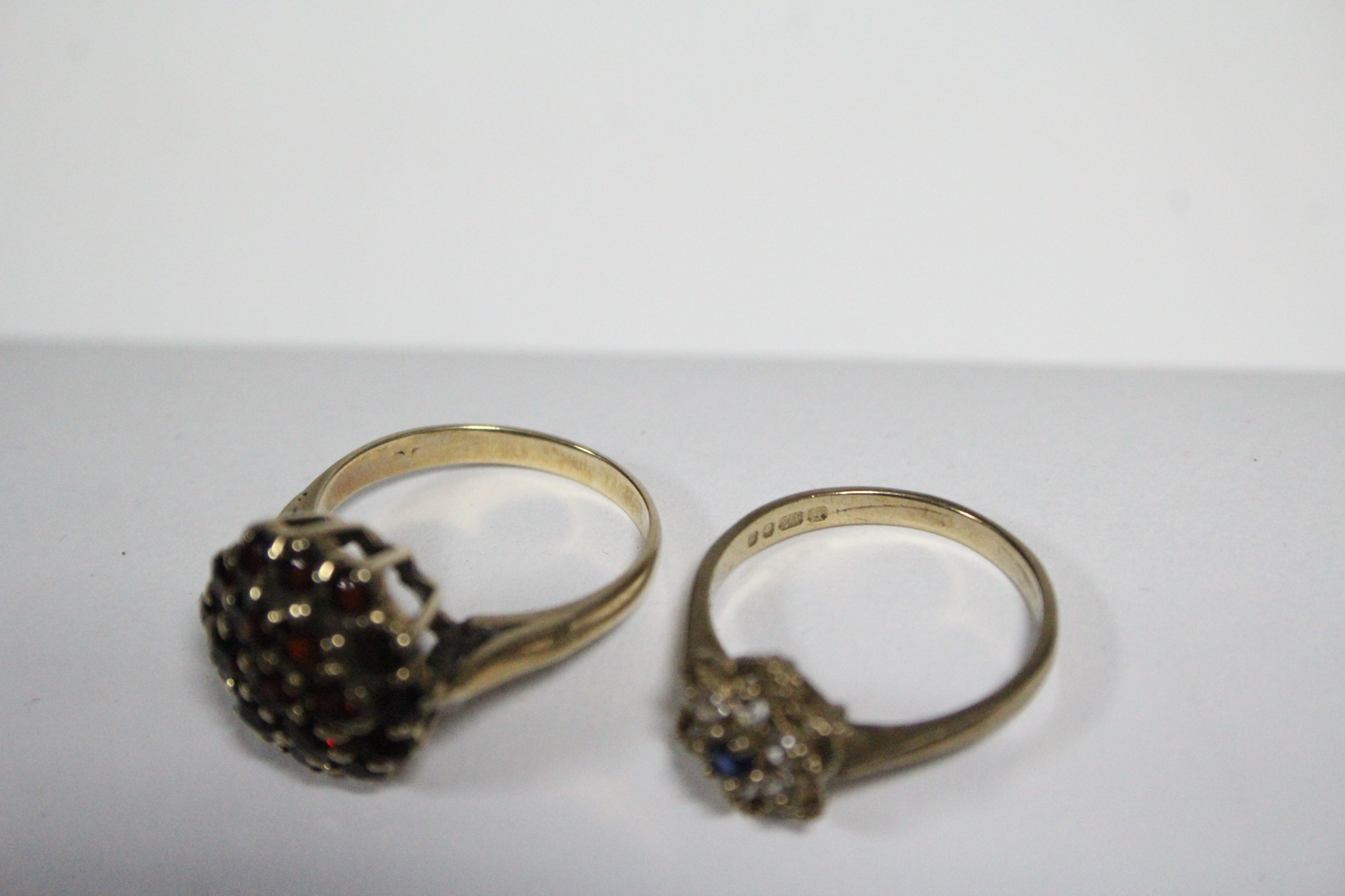 A 9ct. gold ring set cluster of blue & white sapphires; a gold ring set garnet cluster; & a pair - Image 3 of 4