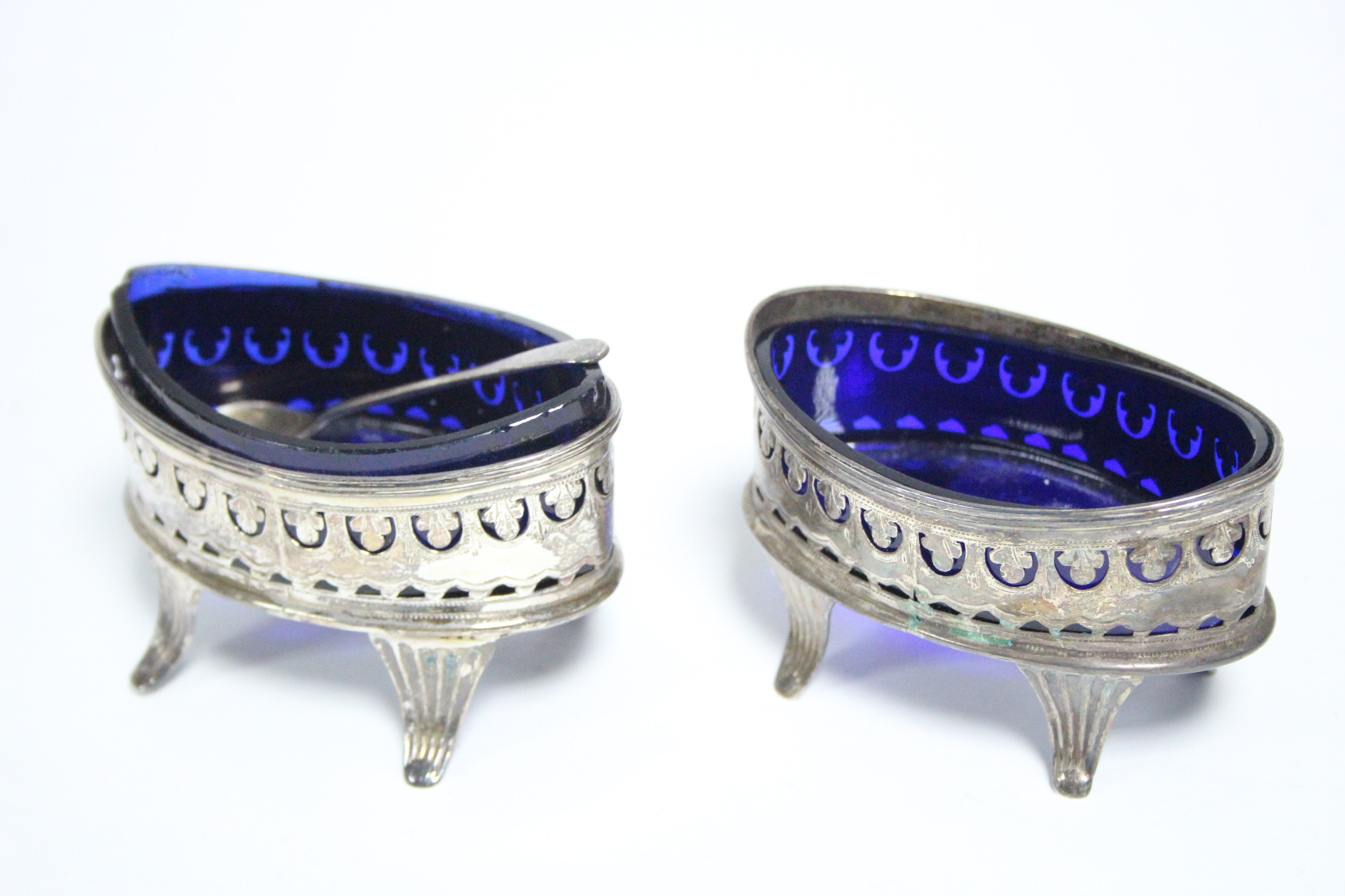 A pair of George III navette-shaped salt cellars with pierced & engraved straight sides, each on