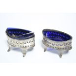 A pair of George III navette-shaped salt cellars with pierced & engraved straight sides, each on