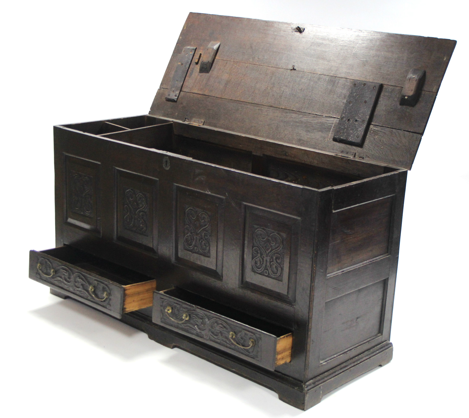 A late 17th century oak coffer with hinged lift-lid, having four carved panels to the front above - Image 2 of 4