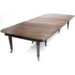 A REGENCY MAHOGANY EXTENDING DINING TABLE, the rectangular top with rounded corners, moulded edge, &