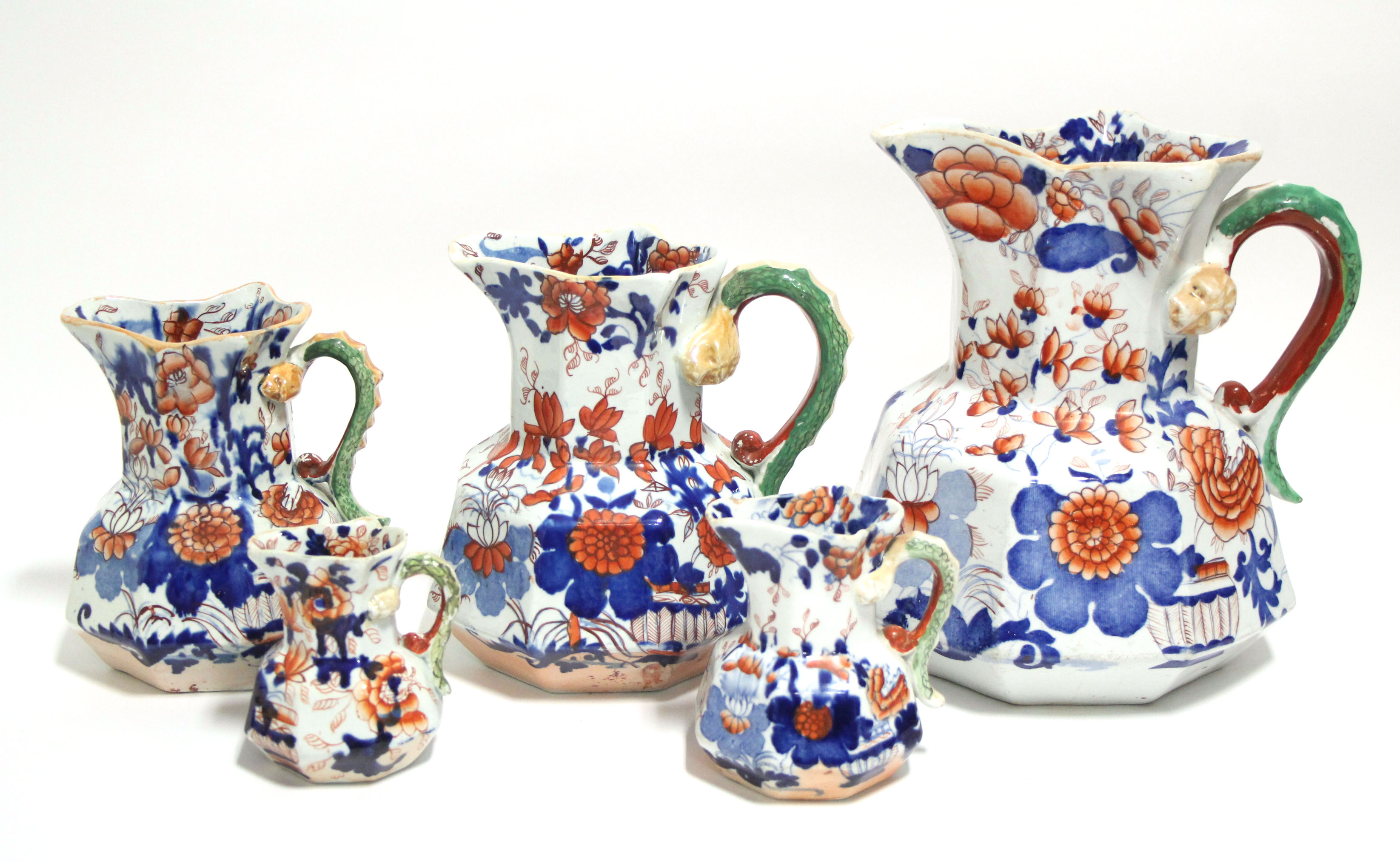 A matched graduated set of five early Mason's Ironstone octagonal baluster "Hydra" jugs with