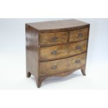 An early 19th century mahogany small bow-front chest fitted two short & two long drawers with