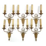 A set of six 18th century style cast metal wall sconces, each with pair of faux candle fittings on