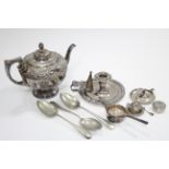 A circular embossed teapot; a chamber candlestick; an ashtray; various spoons, etc.