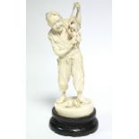 A LATE 19th century JAPANESE IVORY OKIMONO of a standing male farmer holding aloft a fruit-laden