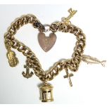 A 9ct. gold curb-link bracelet with six hallmarked pendant charms, & with padlock clasp & safety