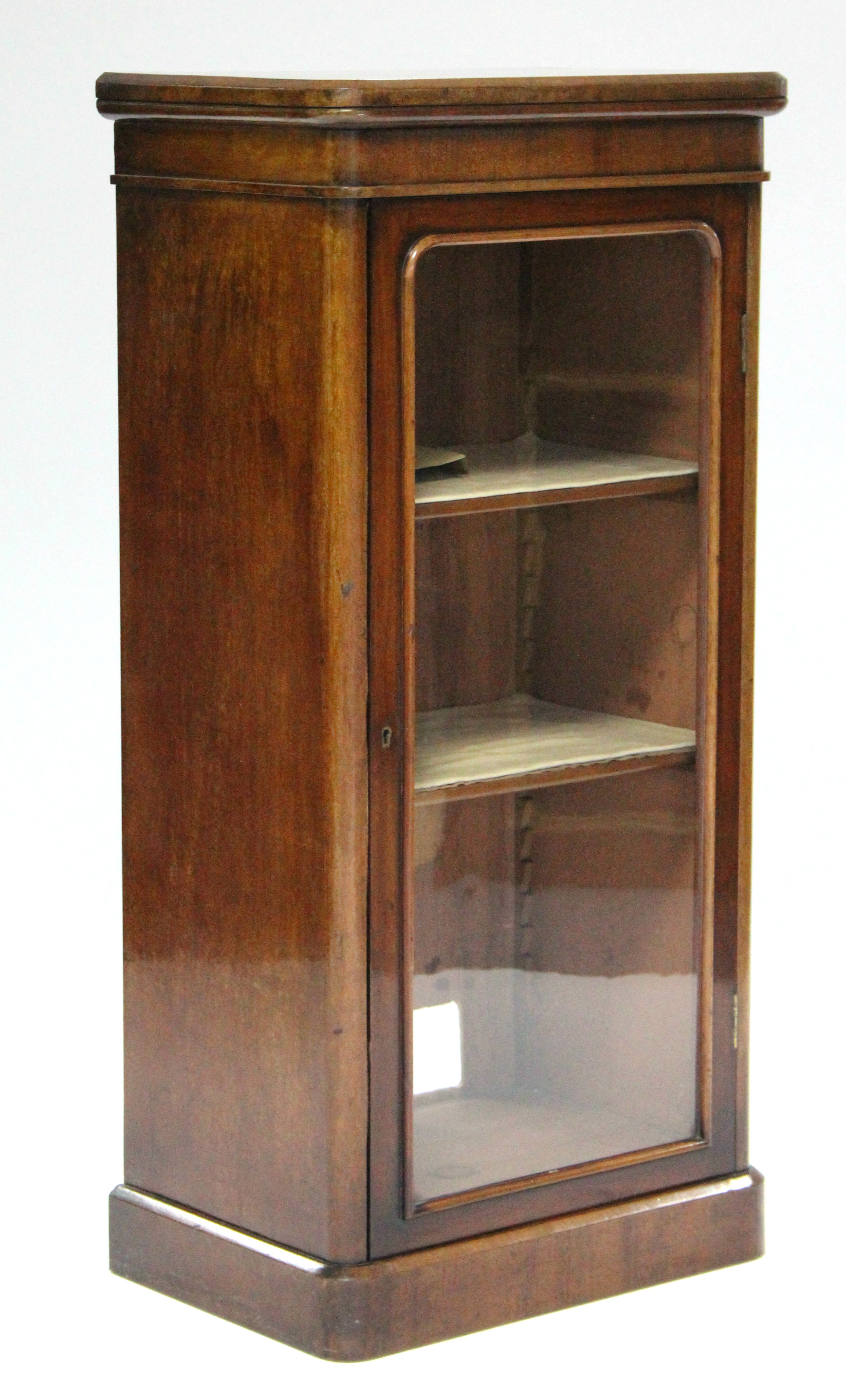 An early Victorian mahogany display cabinet fitted two shelves enclosed by glazed panel door, & on