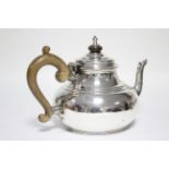 An Irish George V teapot in the early 18th century style, of squat round form, with domed hinged