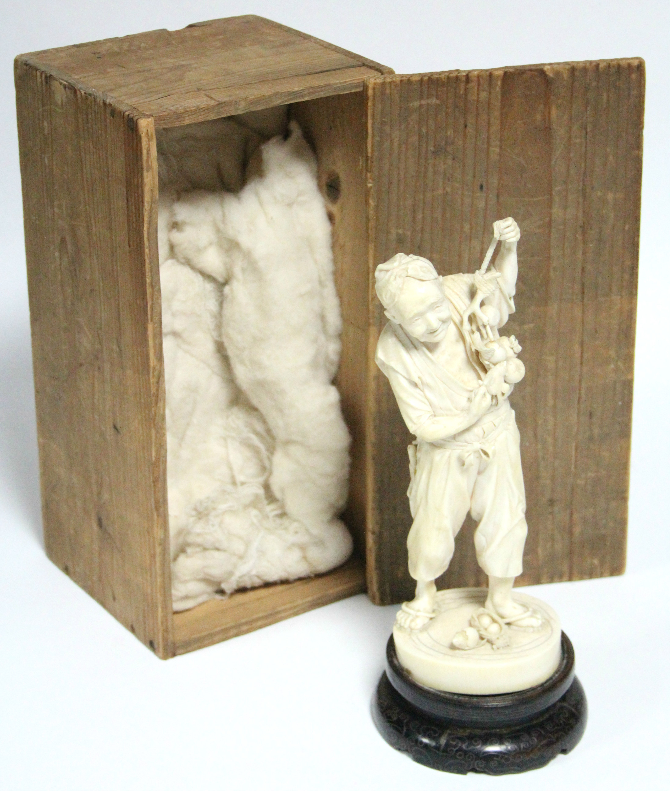 A LATE 19th century JAPANESE IVORY OKIMONO of a standing male farmer holding aloft a fruit-laden - Image 7 of 7