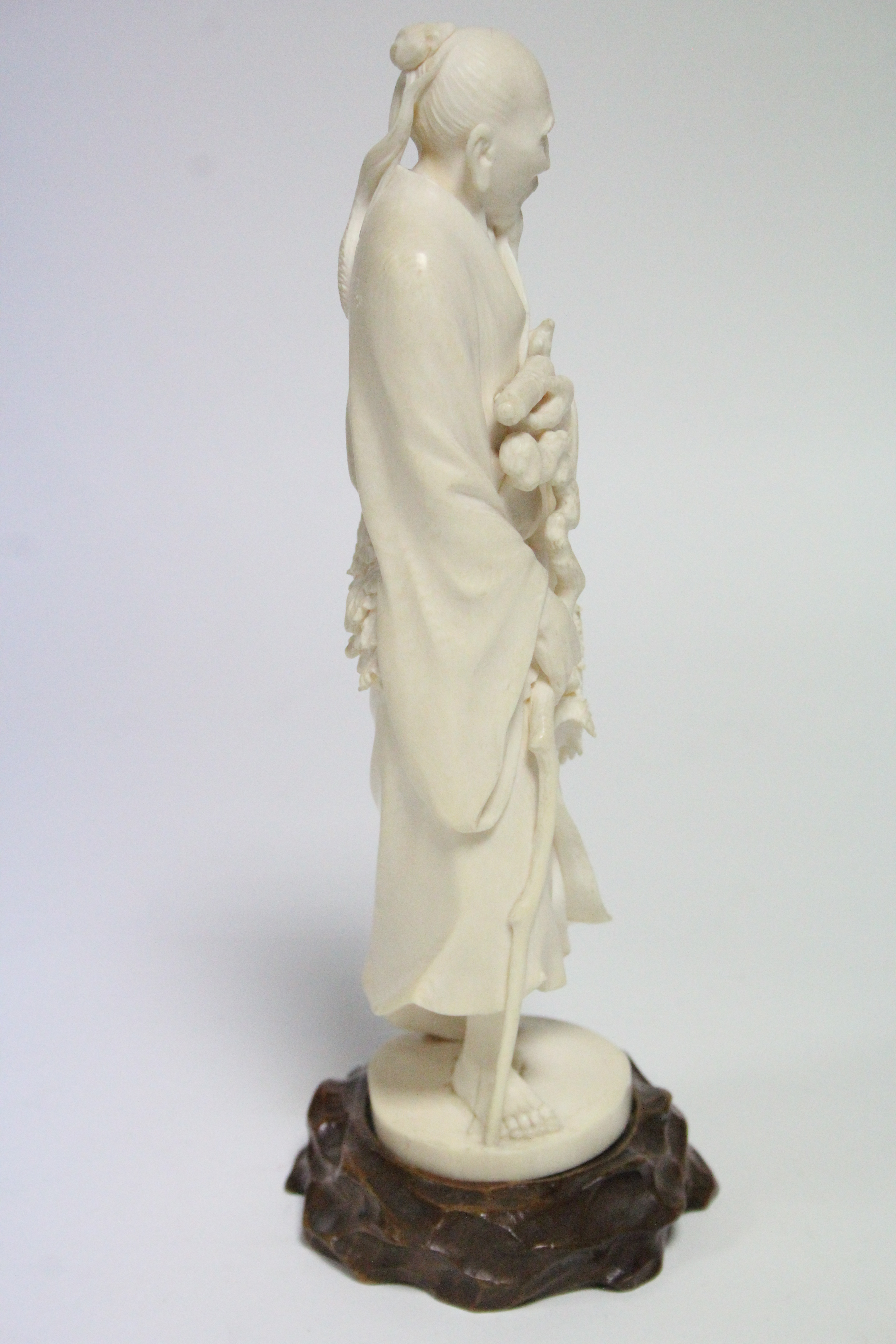 A late 19th century Japanese ivory okimono of a standing male scholar holding a scroll & a staff, - Image 2 of 5