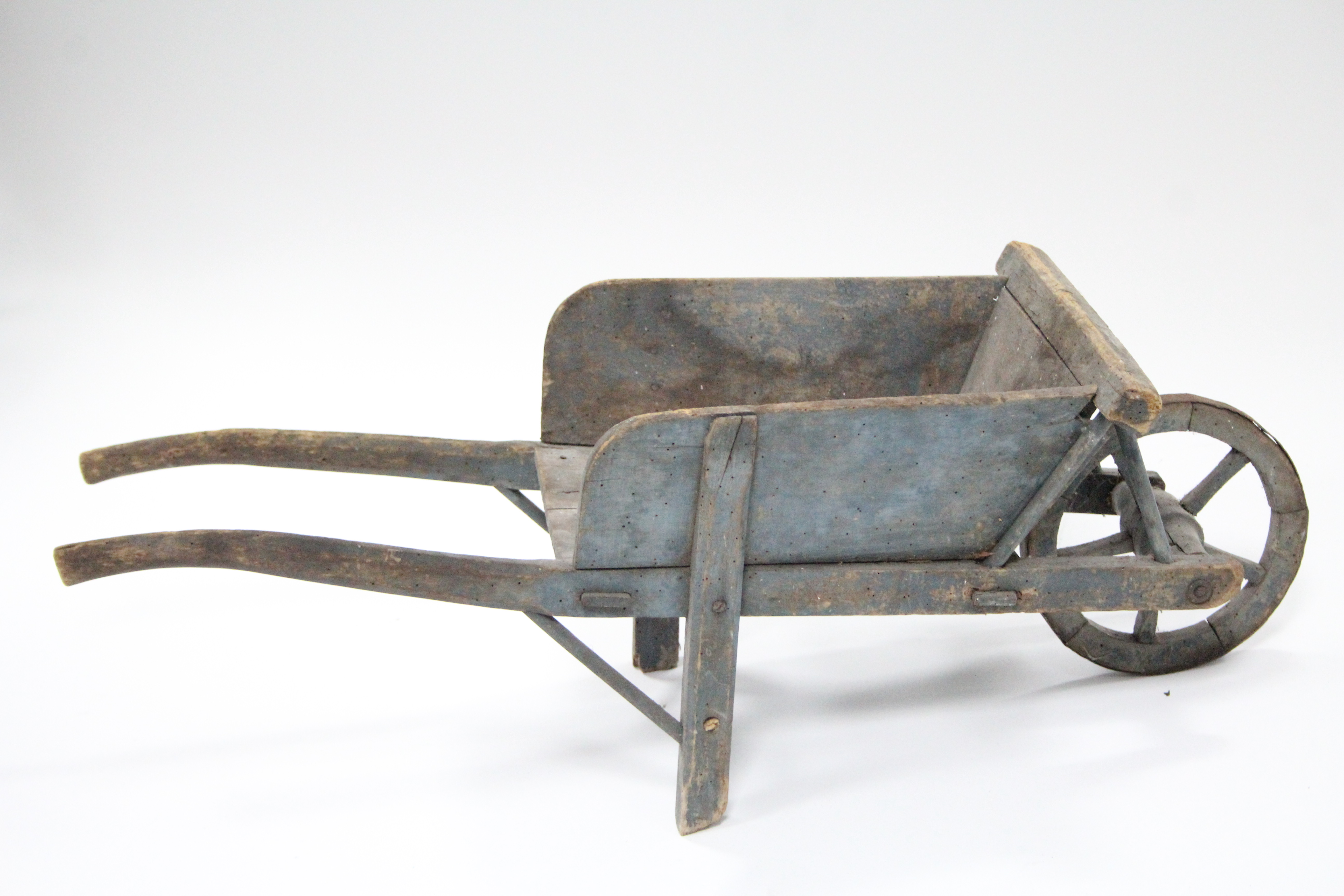 A painted wooden child’s wheelbarrow, 31¾” long, (w.a.f.).