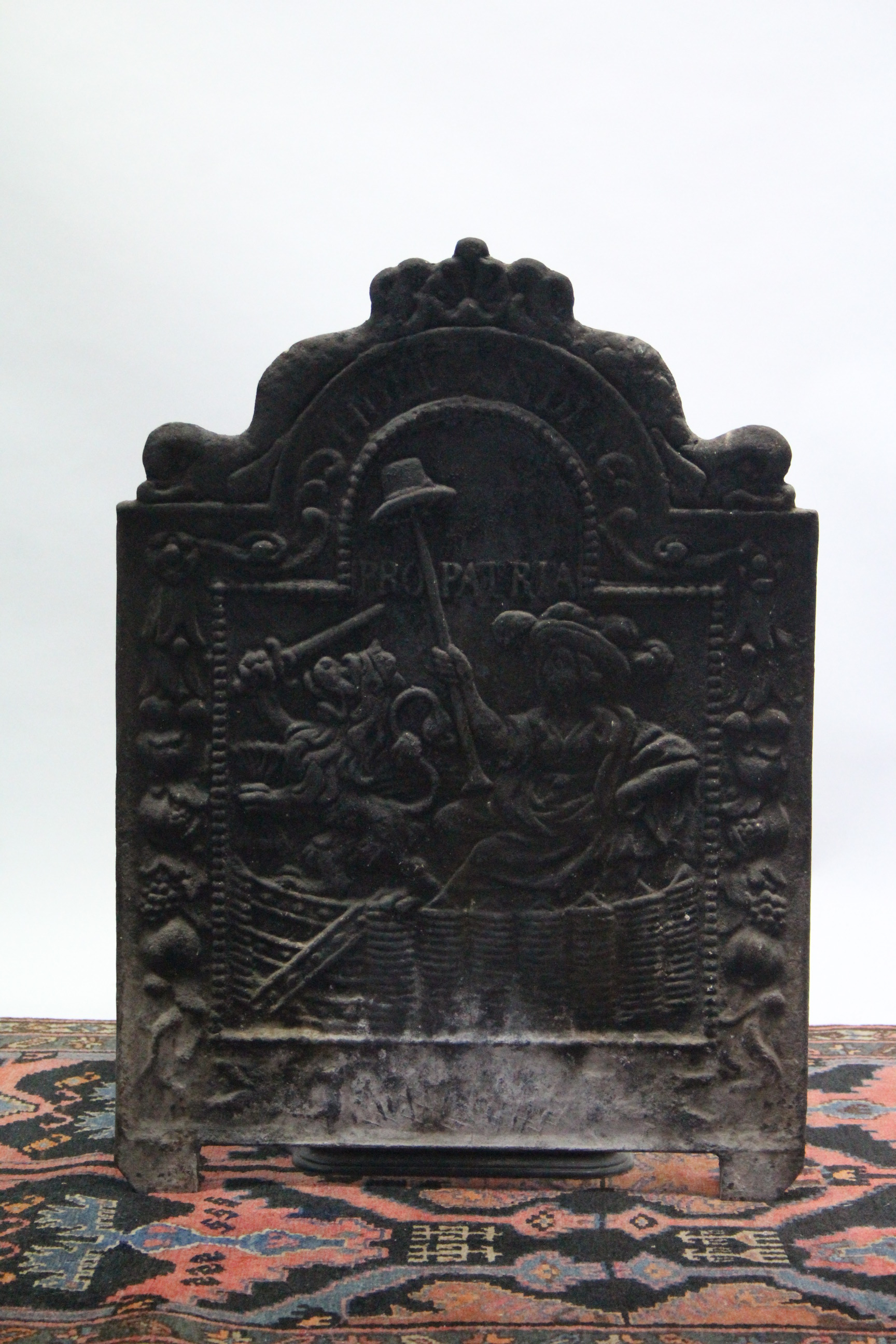 A cast iron fire back with female figure decoration; 21½” wide x 30” high.