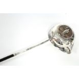 An 18th century punch ladle, the round single-lipped bowl inset Queen Anne medal commemorating the