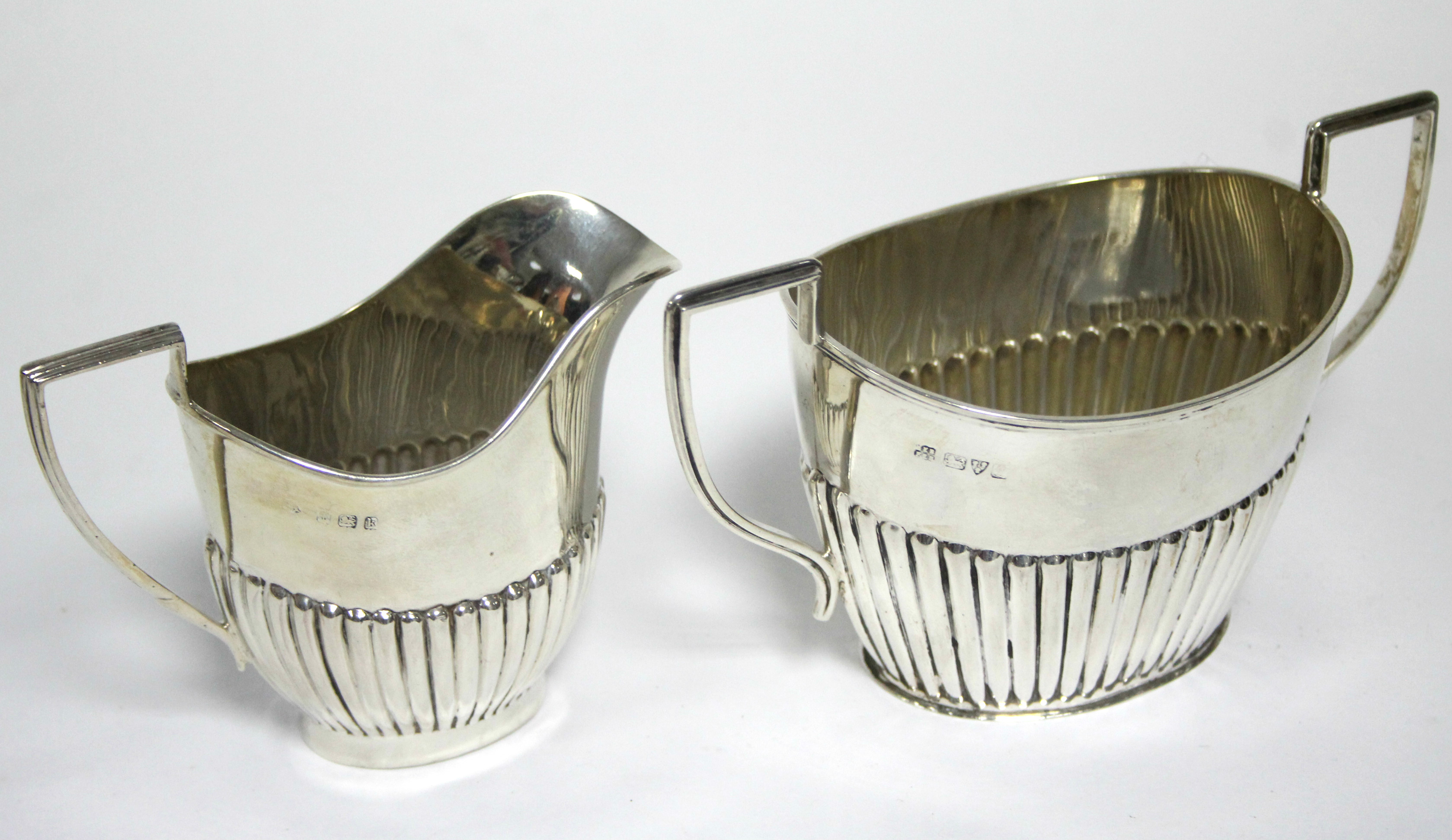 A George V oval semi-fluted two-handled sugar bowl, Chester 1911 by Barker Bros.; & a ditto 3½” milk